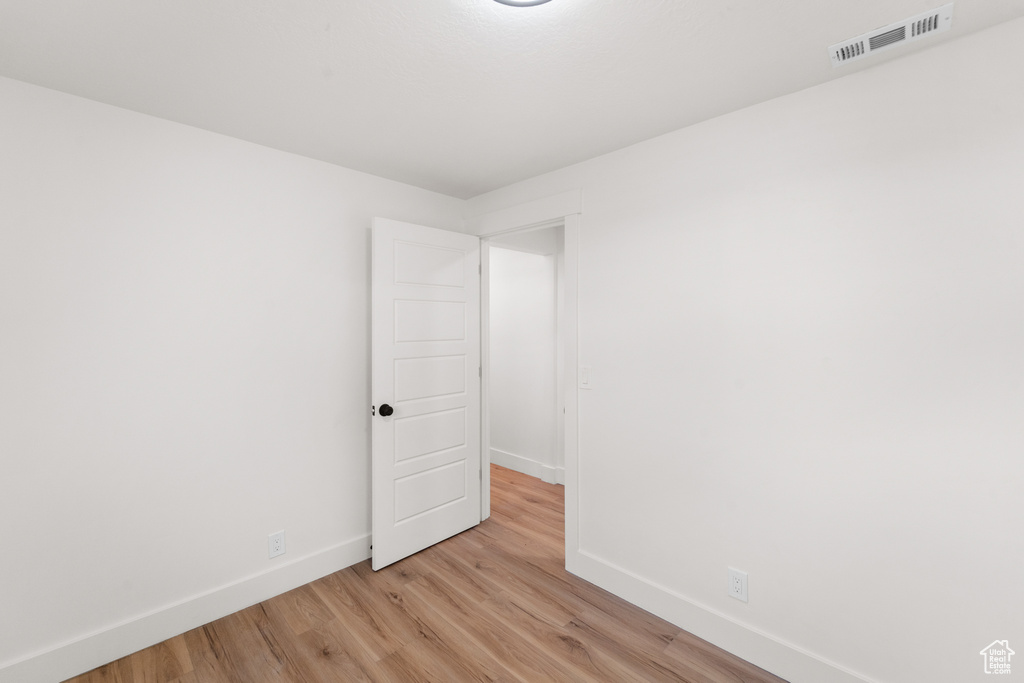 Unfurnished room with baseboards and light wood-type flooring
