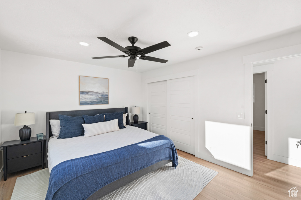 Bedroom featuring light wood-type flooring, a closet, recessed lighting, and ceiling fan
