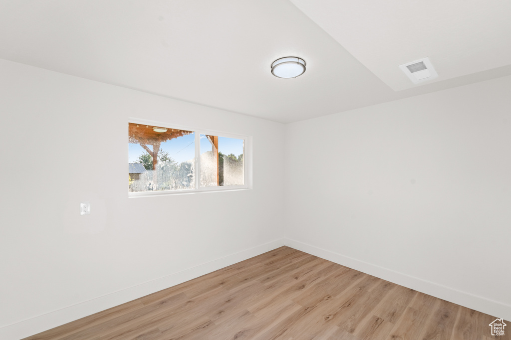 Spare room with light wood-style flooring and baseboards