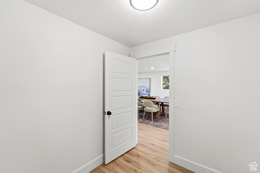 Spare room with baseboards and light wood finished floors