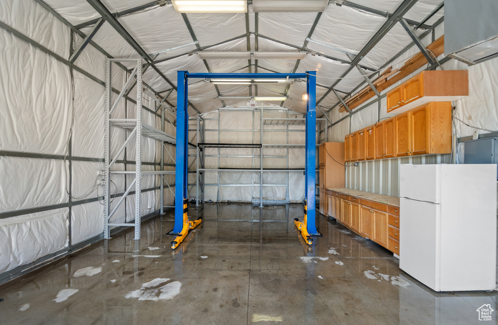 Garage featuring freestanding refrigerator
