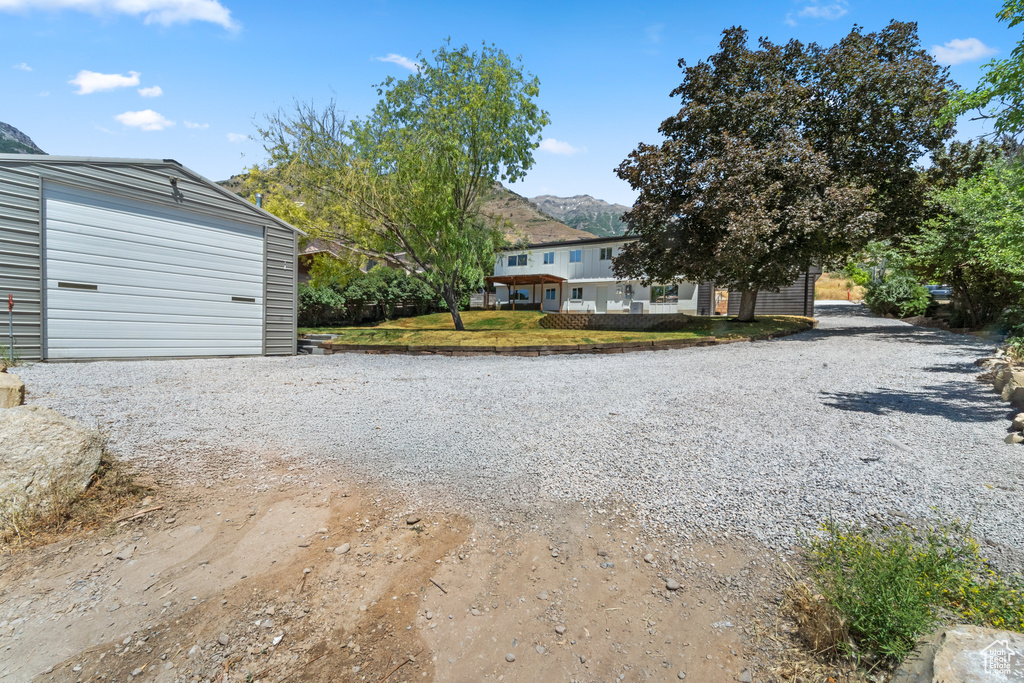 View of dirt / gravel driveway featuring a mountain view