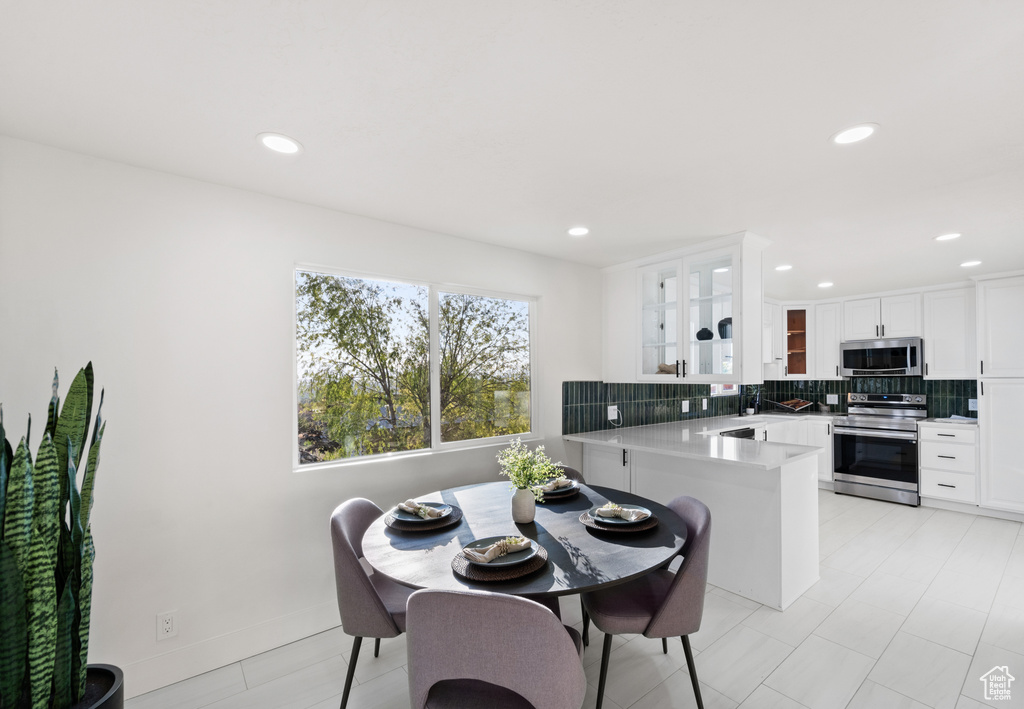Dining space featuring recessed lighting
