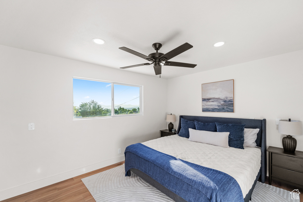 Bedroom featuring wood finished floors, recessed lighting, and a ceiling fan