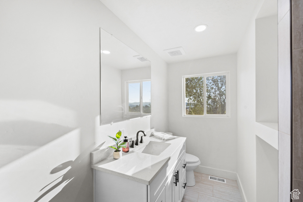 Bathroom with vanity and recessed lighting