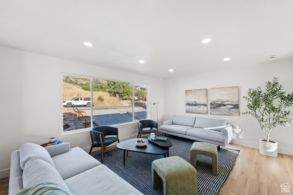 Living room with wood finished floors and recessed lighting