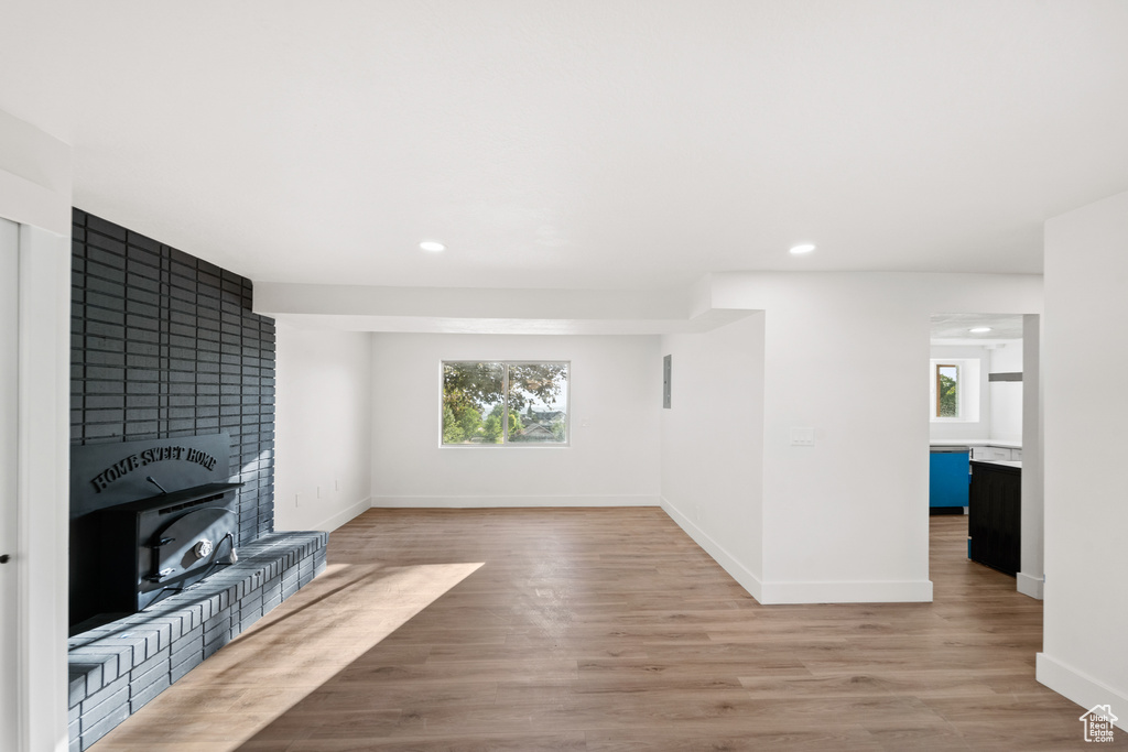 Unfurnished living room featuring wood finished floors and recessed lighting