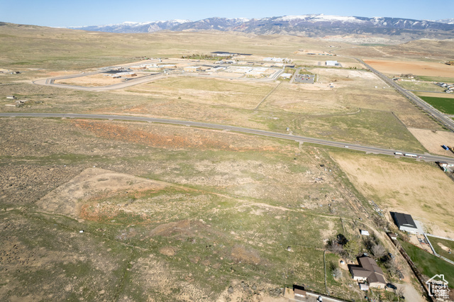 Aerial view of property and surrounding area with rural landscape and a mountainous background