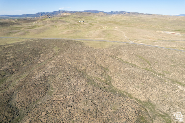 Aerial view of sparsely populated area with a mountain backdrop