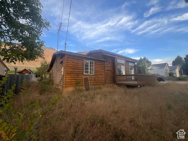 View of side of home with a deck