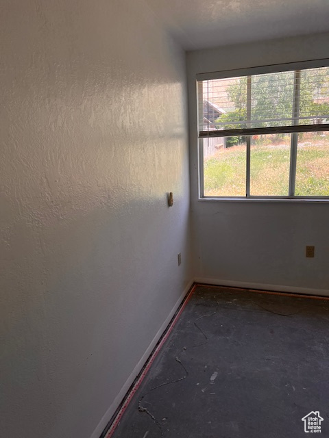 Spare room featuring baseboards