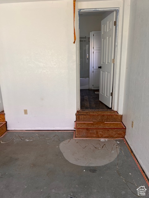 Corridor with unfinished concrete flooring