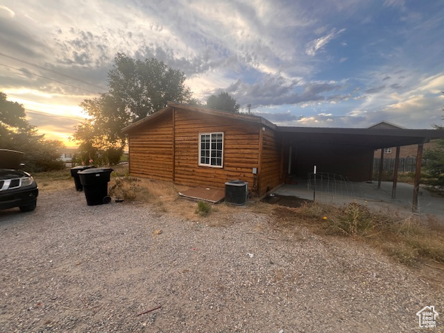 View of side of property with a carport and driveway