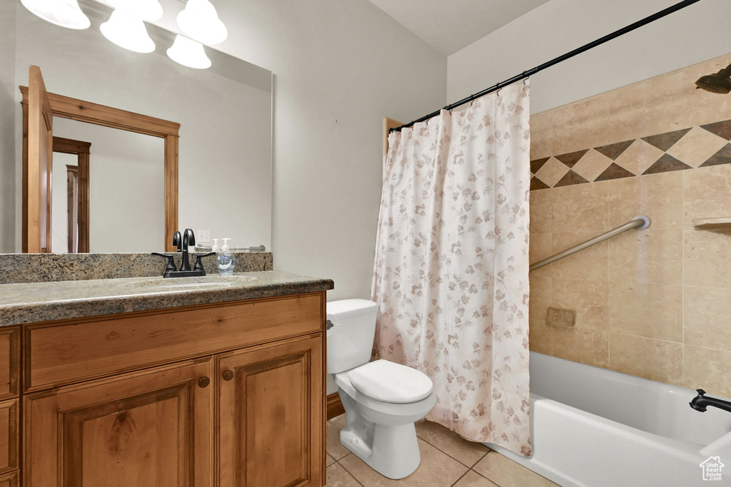 Full bath featuring tile patterned floors, vanity, and shower / bathtub combination with curtain