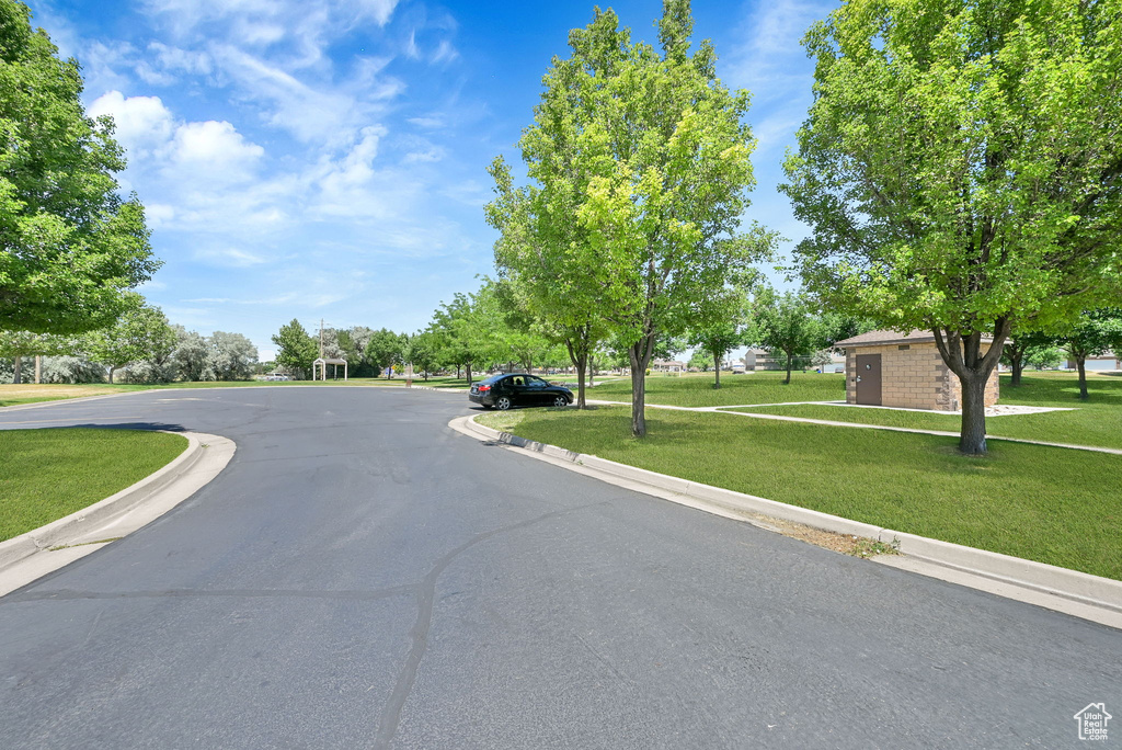 View of asphalt road featuring curbs