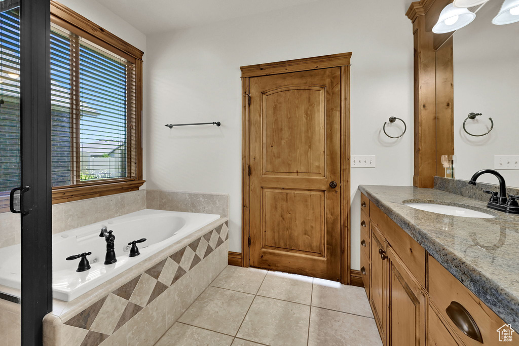 Full bathroom with vanity, tile patterned floors, and a garden tub
