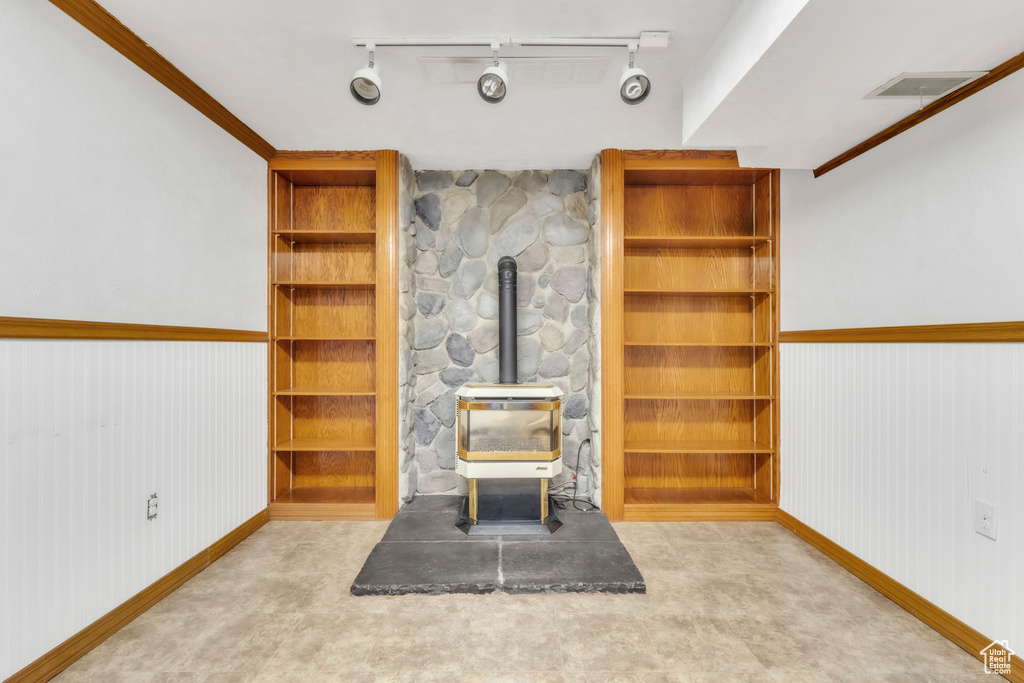 Living area featuring a wood stove and rail lighting