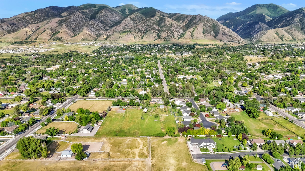 Aerial view of property and surrounding area featuring mountains