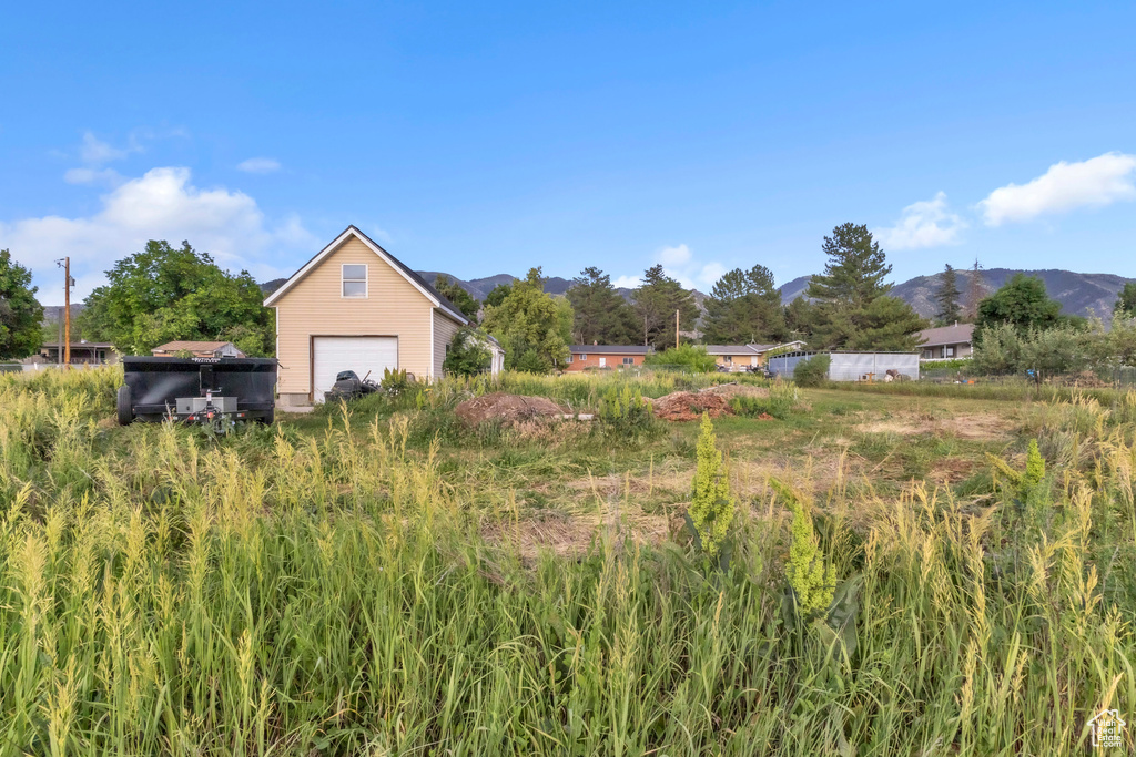 View of yard featuring a garage and a mountain view