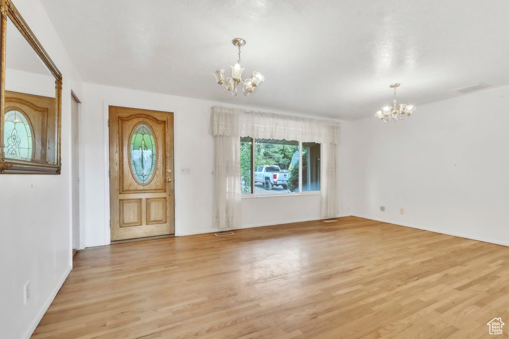 Entryway featuring a chandelier and light wood-style flooring