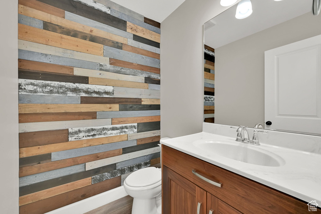 Bathroom featuring wood walls and vanity