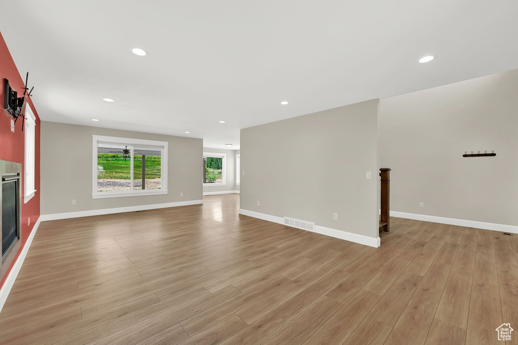 Unfurnished living room featuring light wood-style floors and recessed lighting