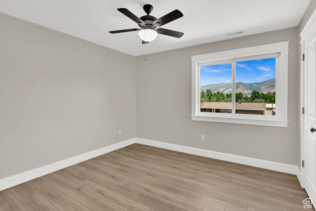 Spare room with light wood-style flooring and a ceiling fan