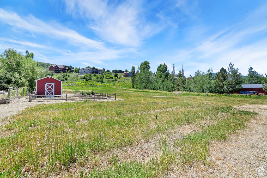 View of yard with an outbuilding, a barn, and a view of countryside