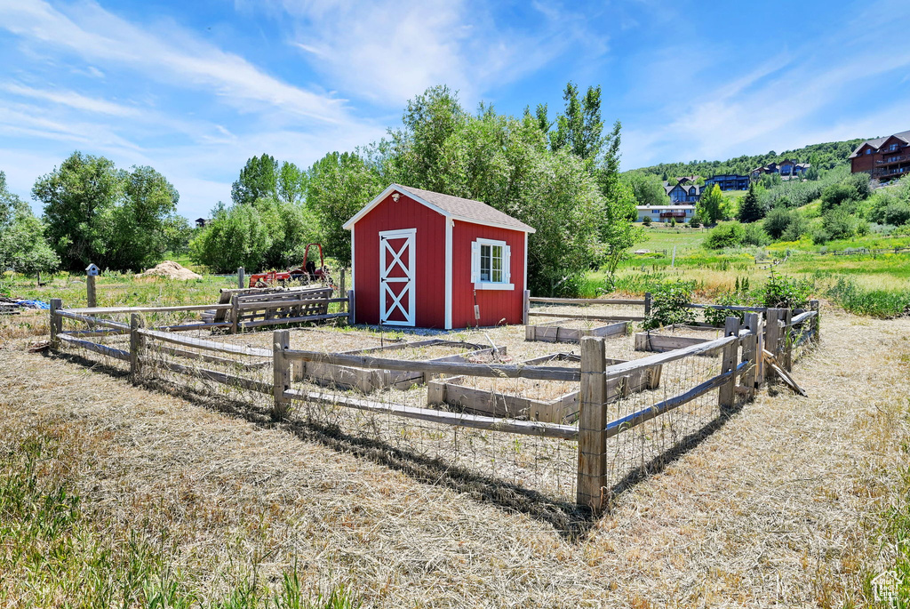 View of shed featuring a garden