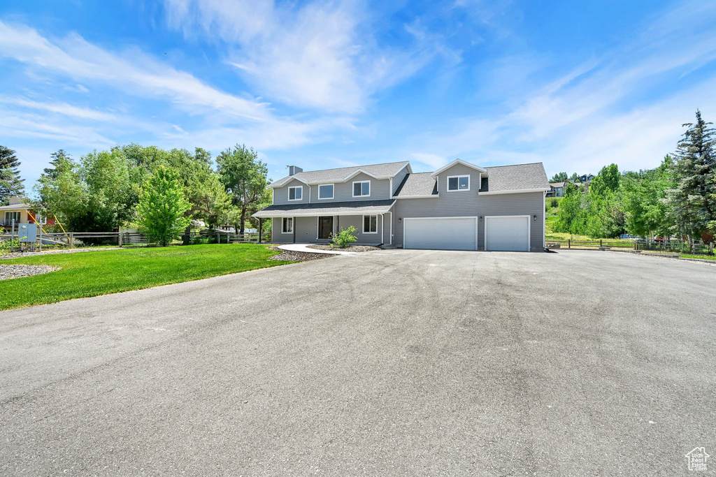 View of front of property featuring driveway and a porch