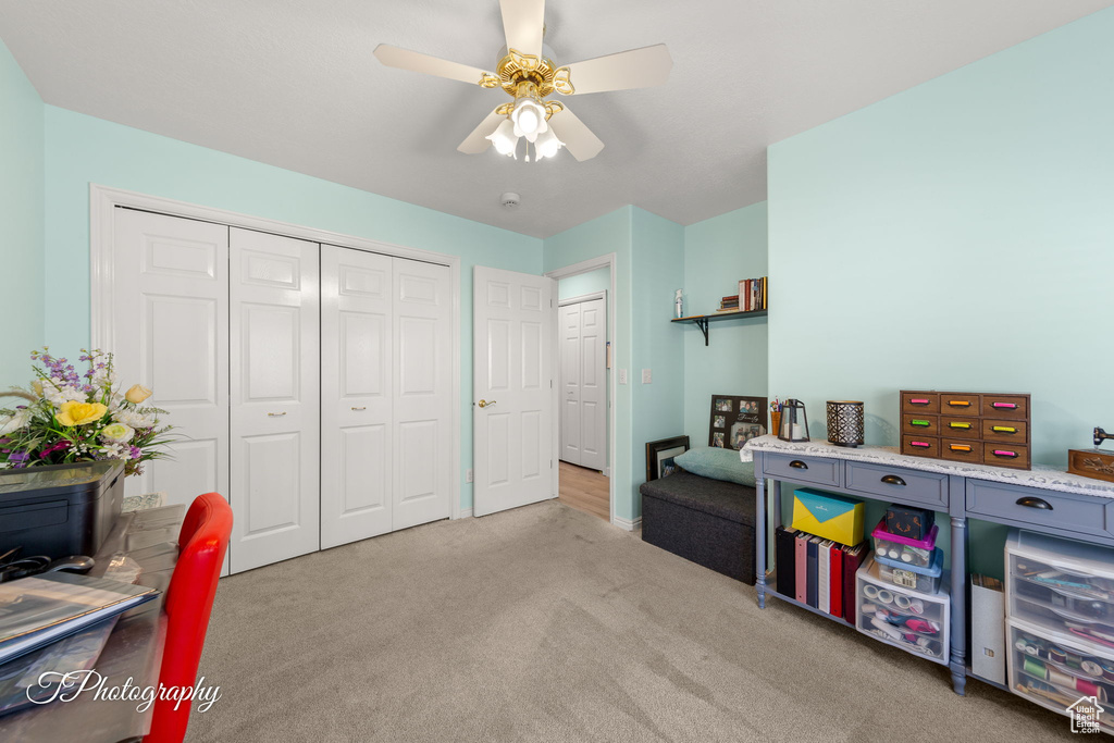 Playroom with carpet floors and a ceiling fan