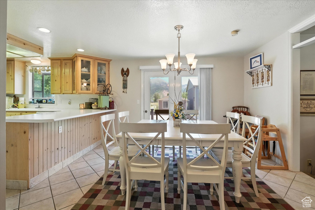 Dining space featuring a chandelier, recessed lighting, and light tile patterned floors