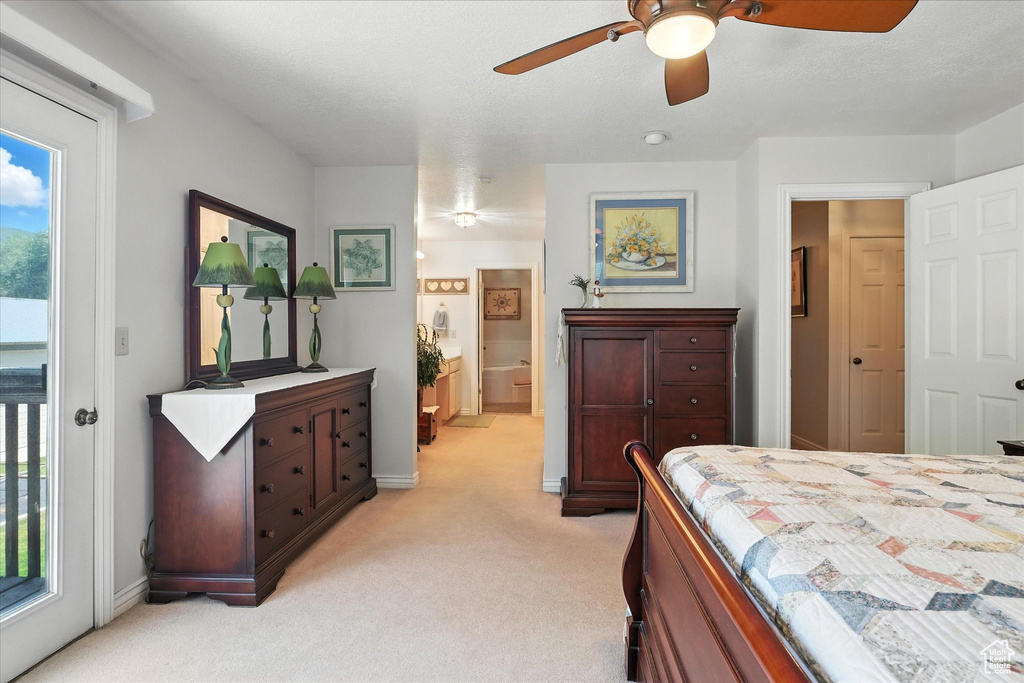 Bedroom with light colored carpet, access to exterior, and ceiling fan