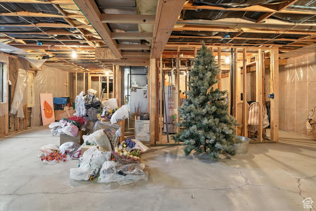 Unfinished below grade area featuring water heater