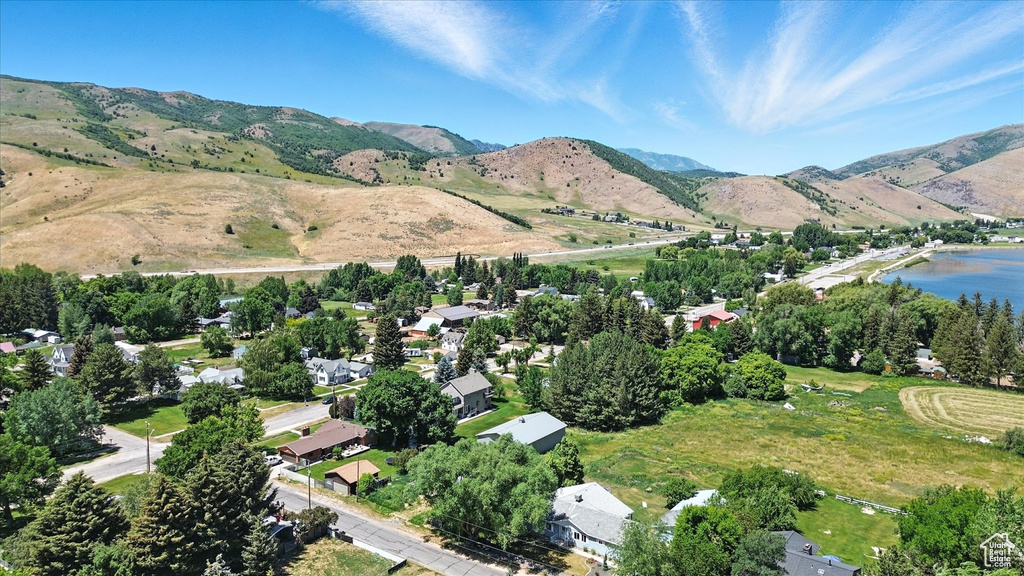 Aerial view of property's location with a water and mountain view