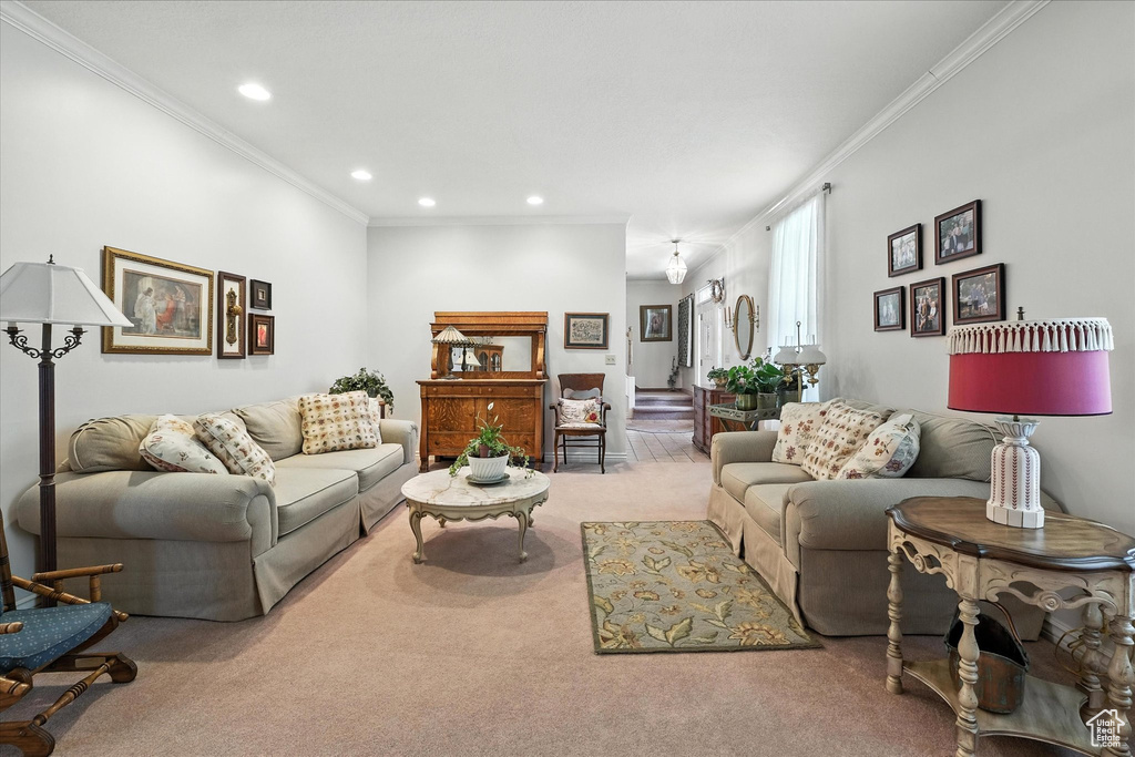 Carpeted living area featuring crown molding and recessed lighting