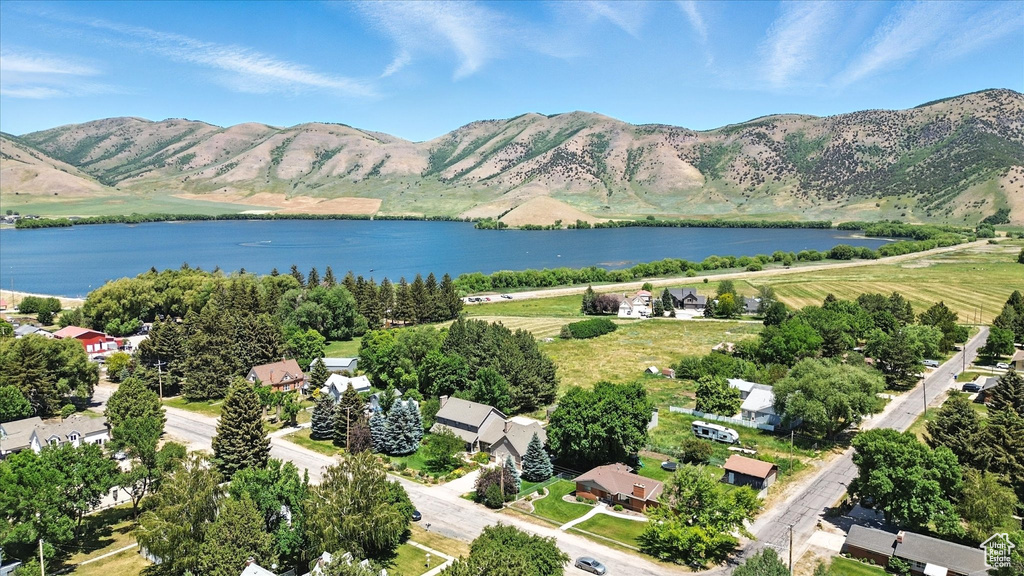 Aerial view of property's location featuring a water and mountain view