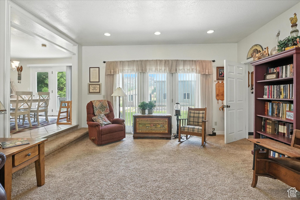 Living area with carpet floors, healthy amount of natural light, french doors, and recessed lighting