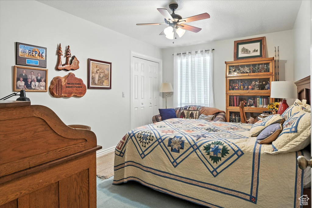 Bedroom featuring carpet floors, a closet, and ceiling fan