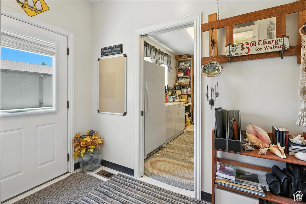 Doorway to outside featuring independent washer and dryer