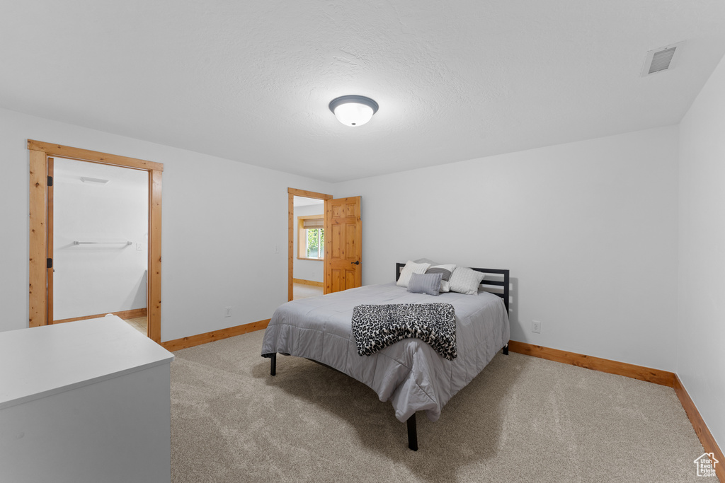 Bedroom with light colored carpet