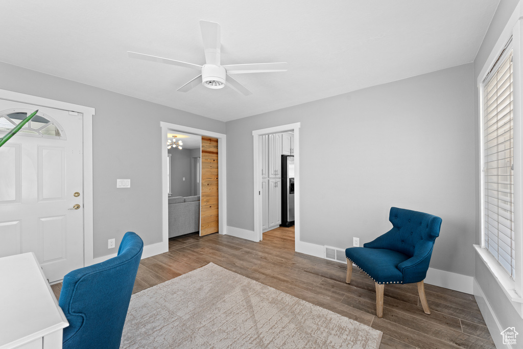 Office area with wood finished floors and a ceiling fan