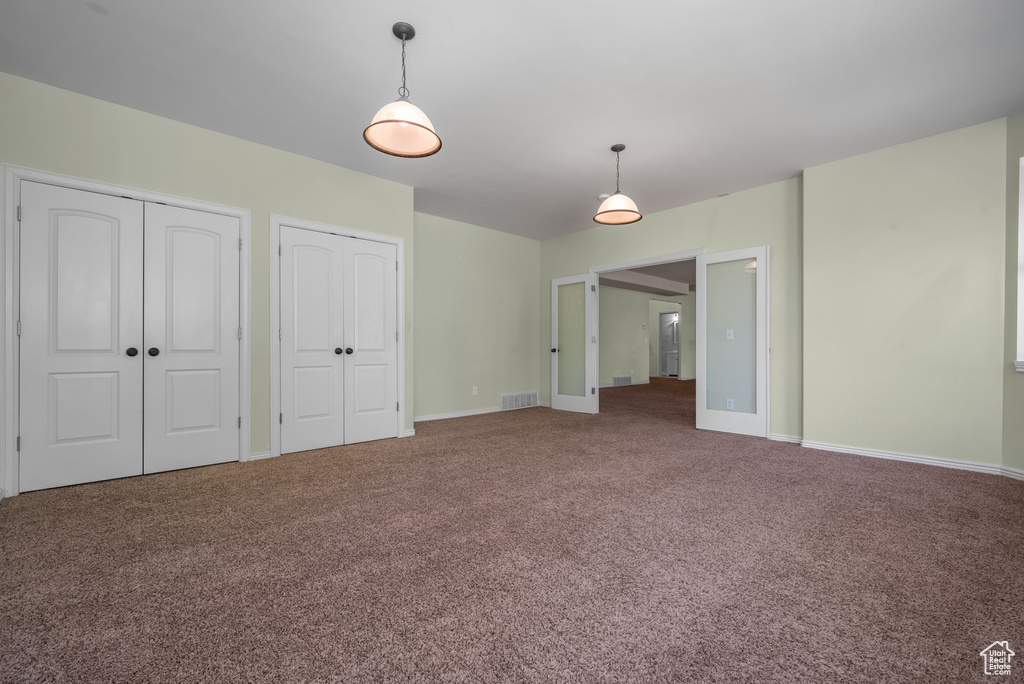 Unfurnished living room with carpet flooring and baseboards