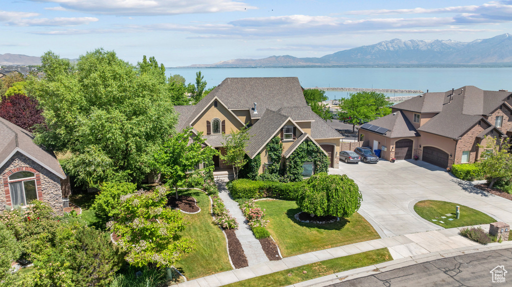 Aerial view of property and surrounding area featuring a water and mountain view