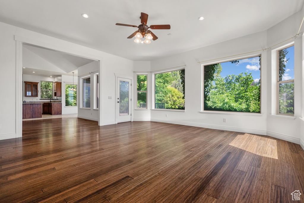 Unfurnished living room featuring a ceiling fan, healthy amount of natural light, wood finished floors, and recessed lighting