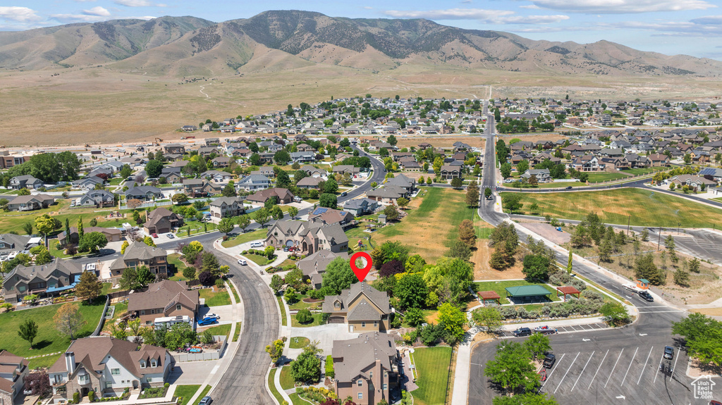 Aerial view of property's location featuring nearby suburban area and mountains