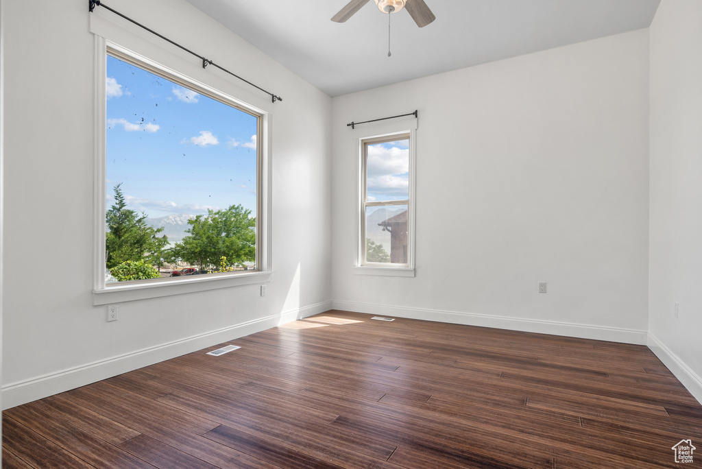 Unfurnished room featuring ceiling fan and wood finished floors