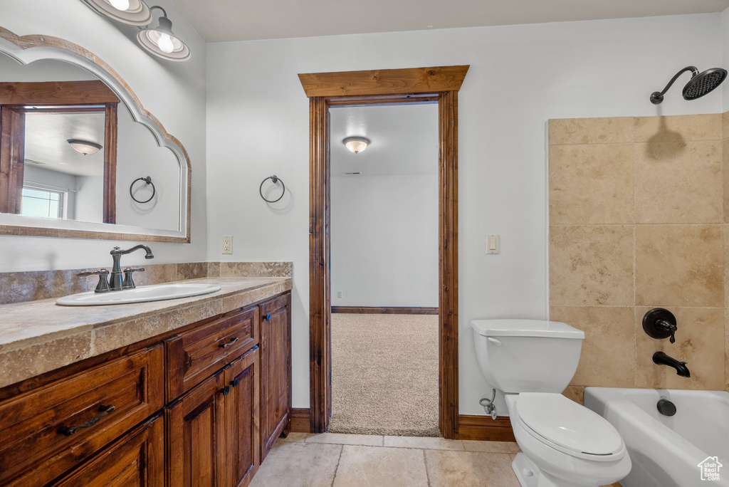 Full bath featuring vanity, shower / bath combination, and tile patterned flooring