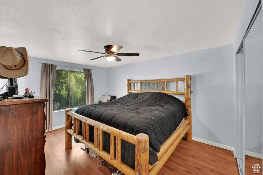 Bedroom featuring wood finished floors and a ceiling fan