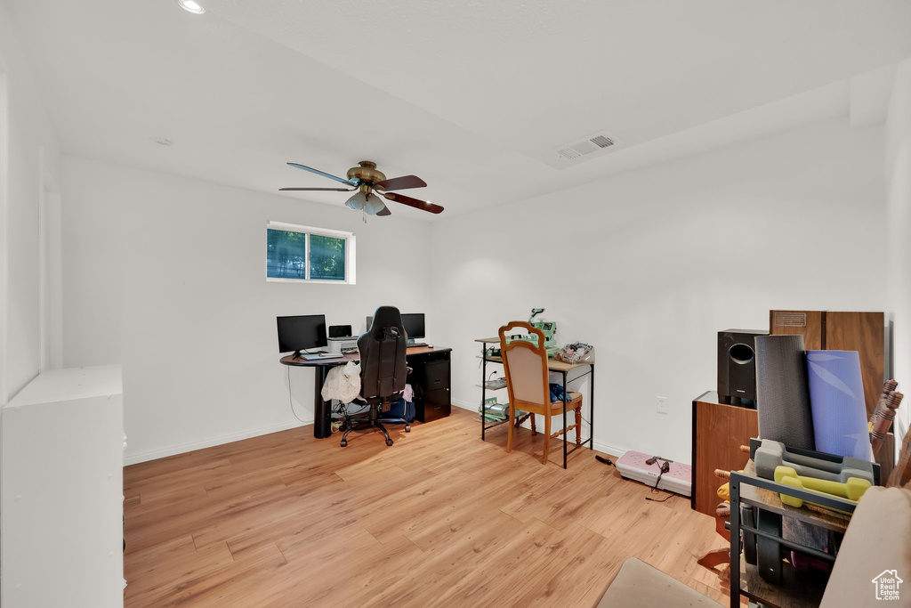 Office area featuring light wood-style floors, ceiling fan, and recessed lighting